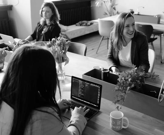 Picture of desk workers smiling