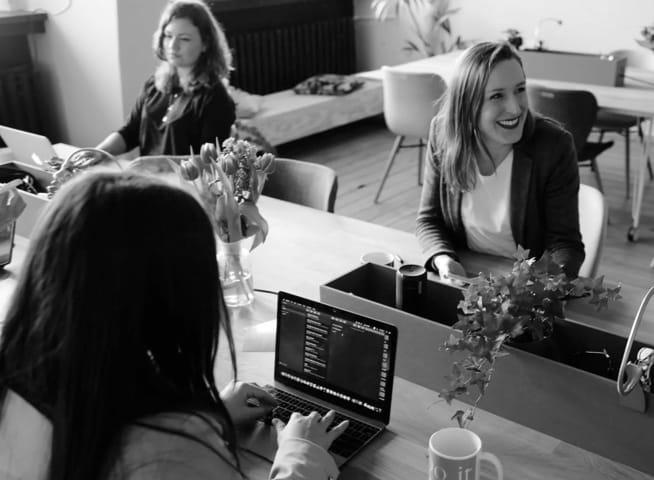 Picture of desk workers smiling